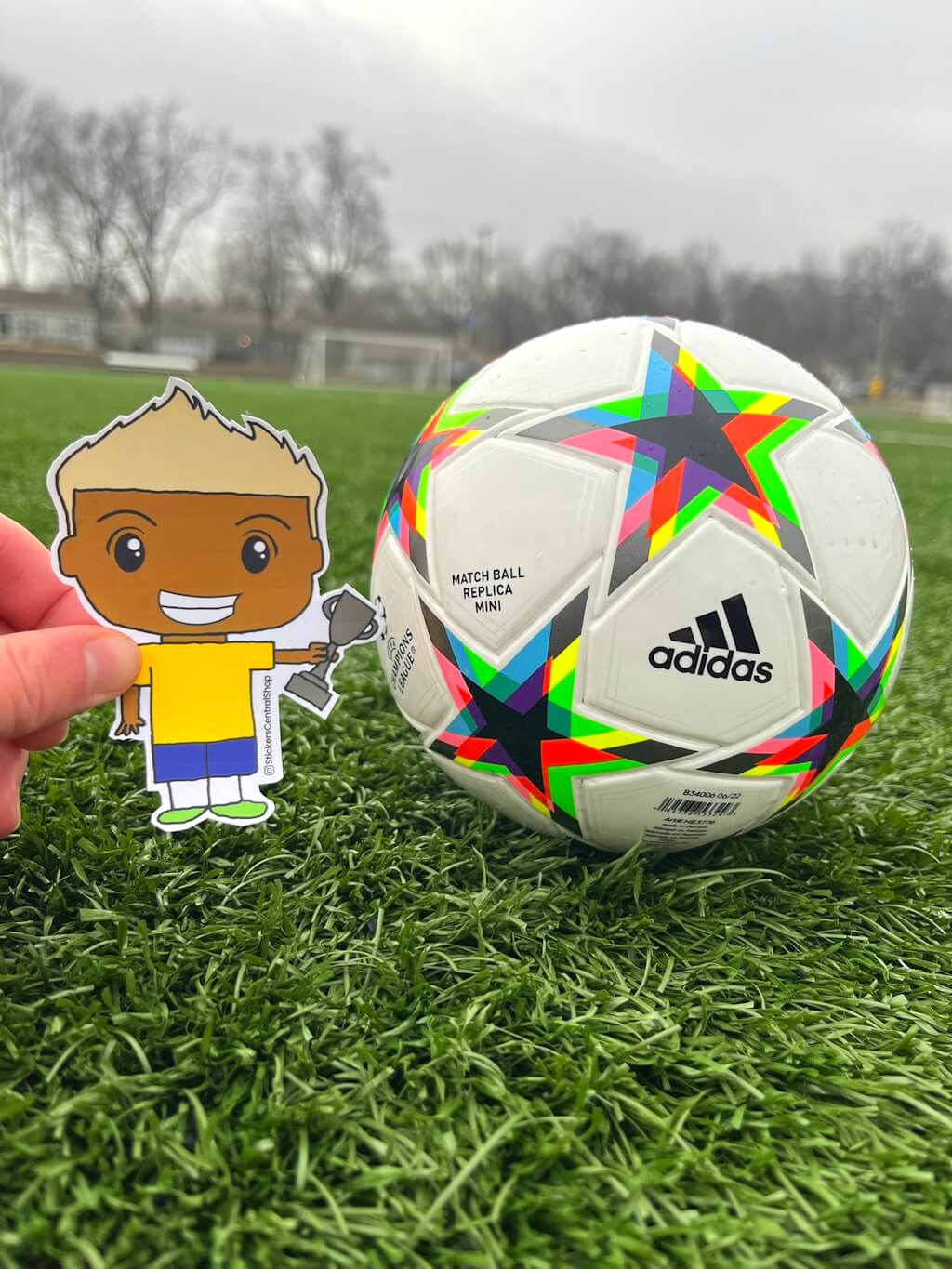 Champion Soccer Player Sticker, yellow and blue with trophy