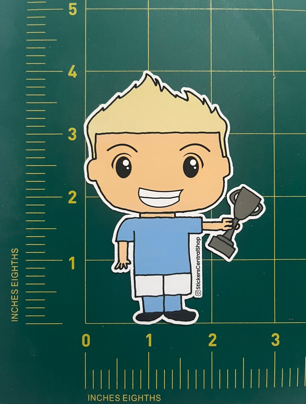 Champion Soccer Player Sticker, light blue and white with trophy