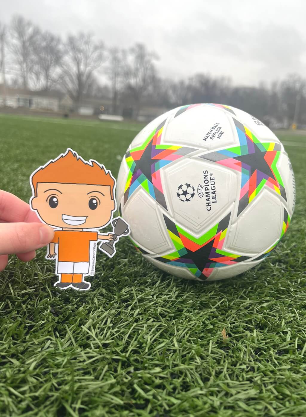 Champion Soccer Player Sticker, orange and white with trophy