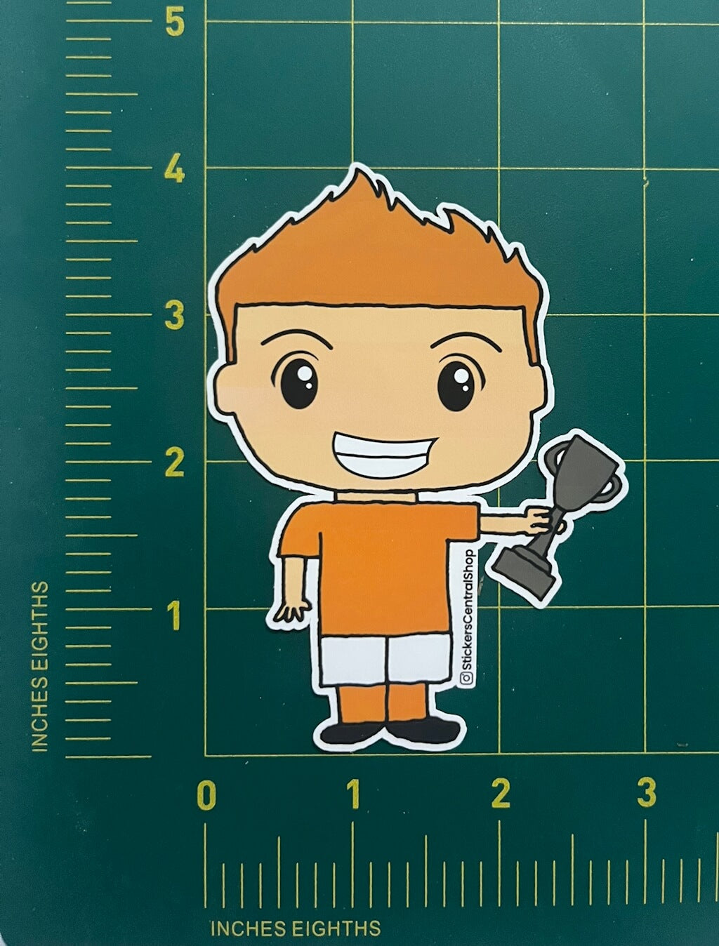 Champion Soccer Player Sticker, orange and white with trophy